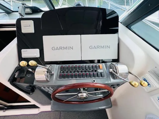  Yacht Photos Pics Tiara Yachts 3800 Open 2003 helm with Garmin navigation displays and wooden steering wheel.