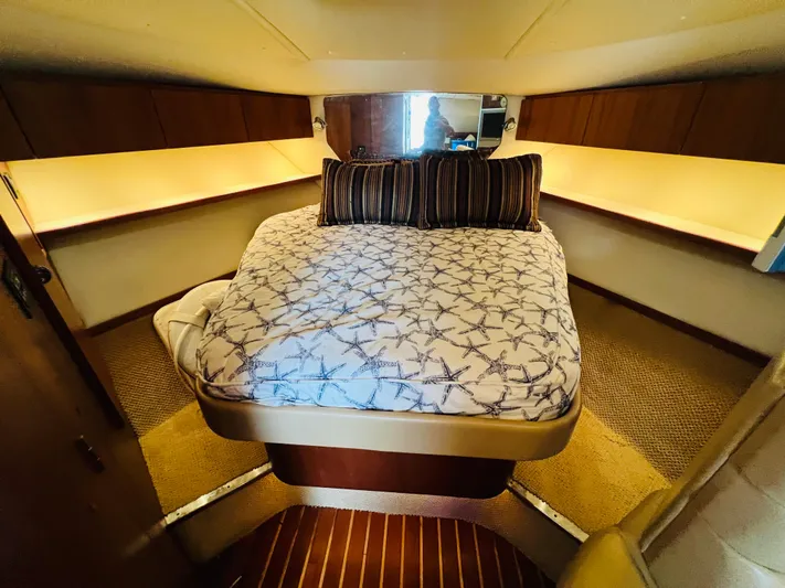  Yacht Photos Pics Luxurious cabin interior of 2003 Tiara Yachts 3800 Open with cozy bed and ambient lighting.