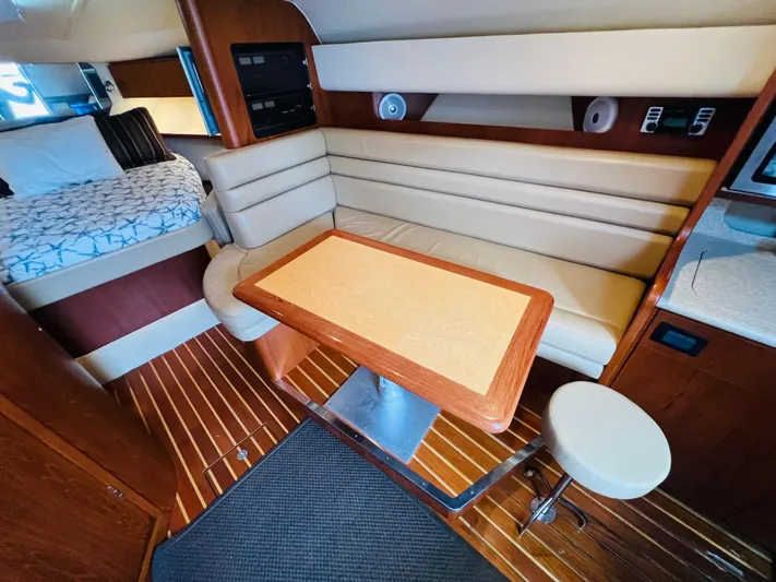  Yacht Photos Pics Interior of 2003 Tiara Yachts 3800 Open with seating and table, wooden flooring.