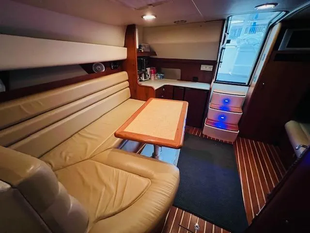  Yacht Photos Pics Interior of 2003 Tiara Yachts 3800 Open with leather seating and wooden flooring.