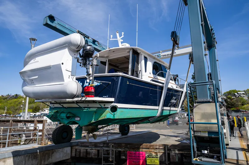 Tangled Up In Blue Yacht Photos Pics 2013 Back Cove 37 boat being lifted at a marina.