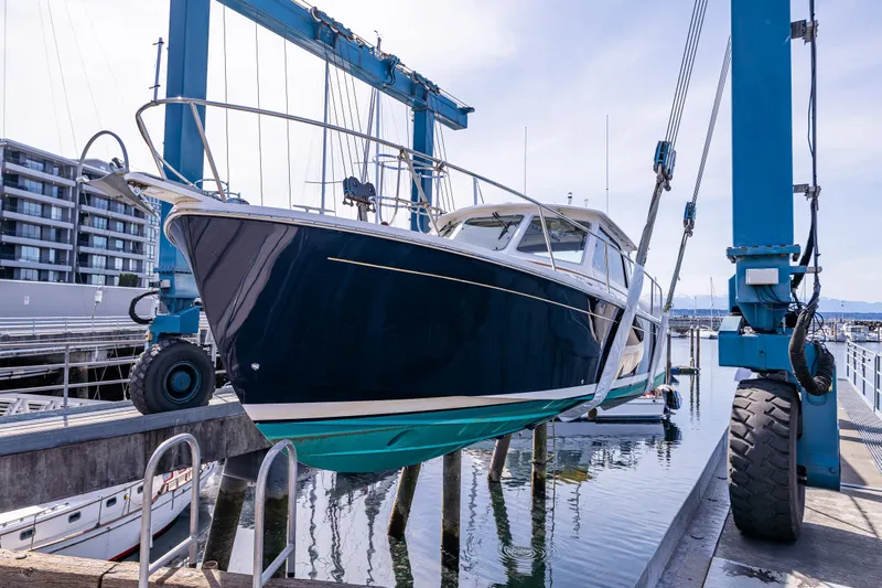 Tangled Up In Blue Yacht Photos Pics 2013 Back Cove 37 yacht in dry dock, marina background.