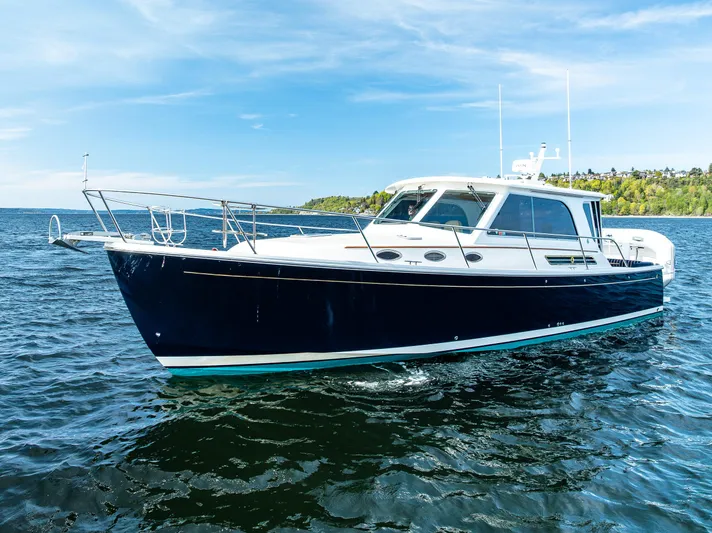 Tangled Up In Blue Yacht Photos Pics 2013 Back Cove 37 boat cruising on open water under a clear blue sky.
