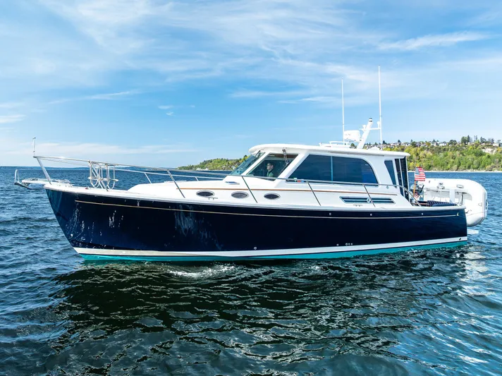 Tangled Up In Blue Yacht Photos Pics 2013 Back Cove 37 boat cruising on open water under a clear blue sky.