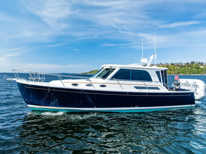 Tangled Up In Blue Yacht Photos Pics 2013 Back Cove 37 yacht cruising on a sunny day with clear blue skies.