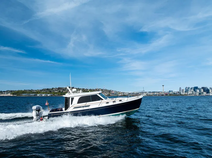 Tangled Up In Blue Yacht Photos Pics 2013 Back Cove 37 cruising on open water under a clear blue sky.