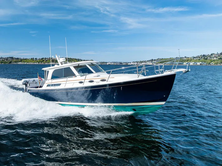 Tangled Up In Blue Yacht Photos Pics 2013 Back Cove 37 cruising on open water under a clear blue sky.