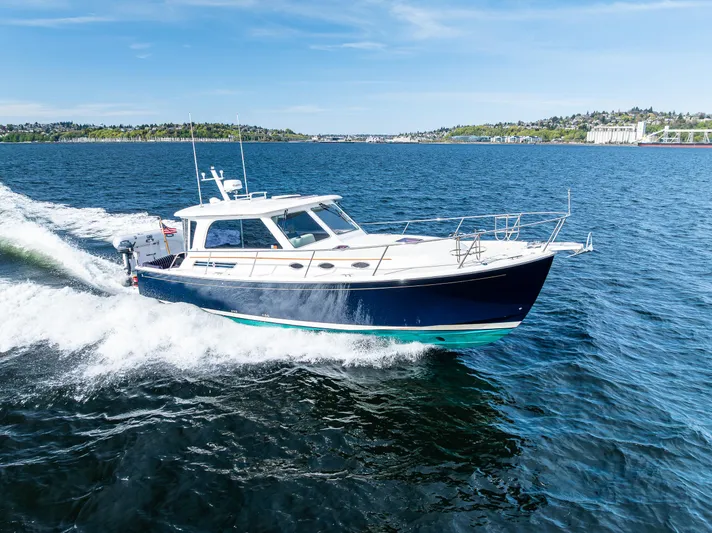 Tangled Up In Blue Yacht Photos Pics 2013 Back Cove 37 cruising on open water under clear blue skies.