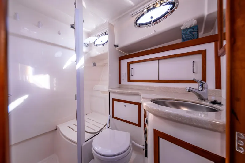 Tangled Up In Blue Yacht Photos Pics Luxurious bathroom in 2013 Back Cove 37 yacht, featuring modern fixtures and elegant wood accents.