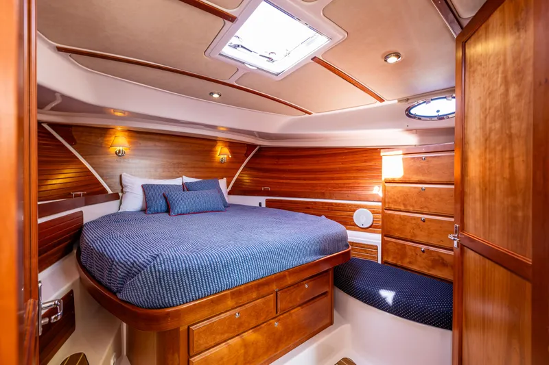 Tangled Up In Blue Yacht Photos Pics Luxurious cabin interior of 2013 Back Cove 37 yacht with wood finish and cozy bedding.