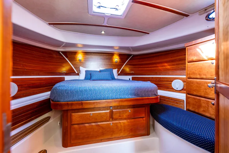 Tangled Up In Blue Yacht Photos Pics Luxurious cabin interior of 2013 Back Cove 37 yacht with wood finish and cozy bedding.