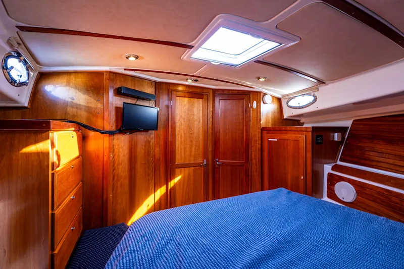 Tangled Up In Blue Yacht Photos Pics Luxurious cabin interior of 2013 Back Cove 37 yacht with wood paneling and skylight.