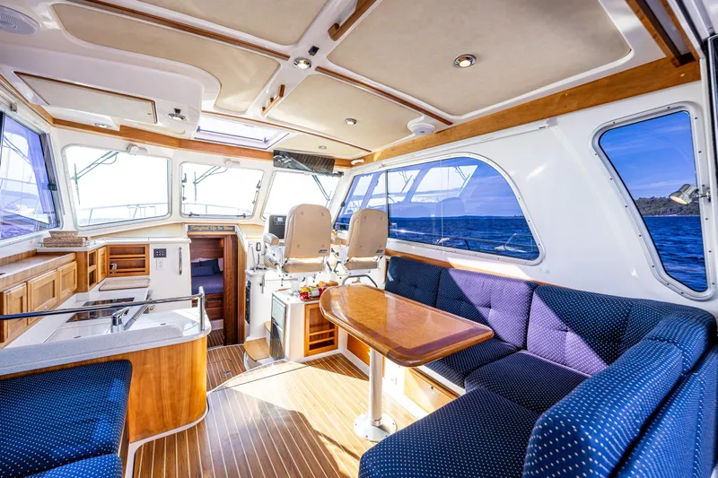 Tangled Up In Blue Yacht Photos Pics Interior of 2013 Back Cove 37 yacht with elegant seating and wooden finishes.