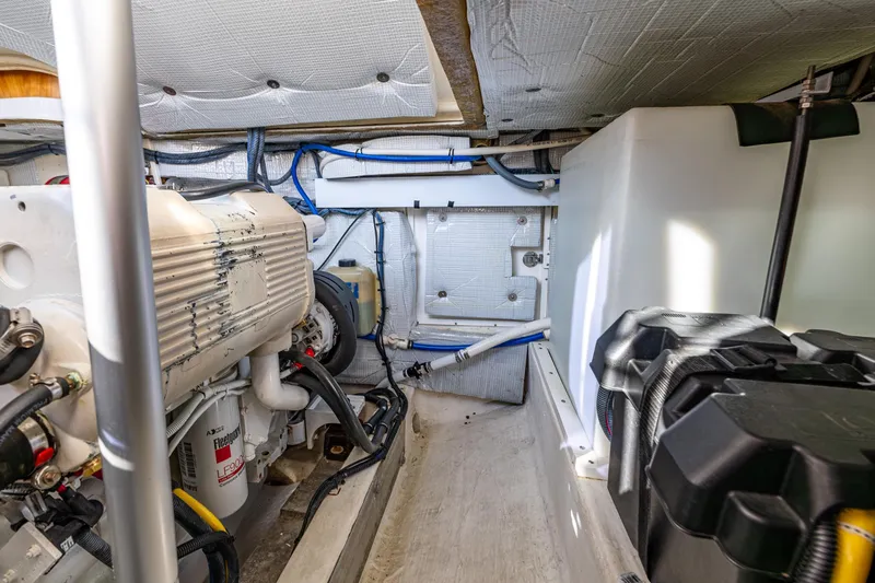 Tangled Up In Blue Yacht Photos Pics Engine room of 2013 Back Cove 37 boat, showcasing mechanical components and storage.