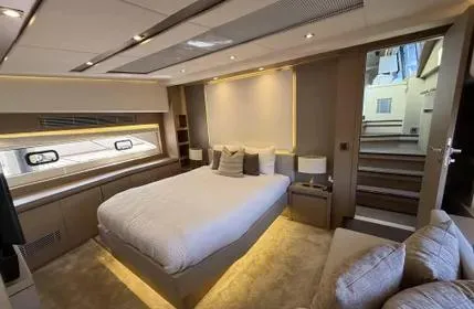  Yacht Photos Pics Luxurious bedroom interior of 2018 Prestige 680 yacht with modern design and ambient lighting.