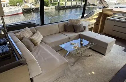  Yacht Photos Pics Luxurious interior of a 2018 Prestige 680 yacht with plush seating and glass table.