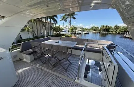  Yacht Photos Pics Luxurious 2018 Prestige 680 yacht deck with seating, table, and waterfront view.