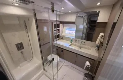  Yacht Photos Pics Luxurious bathroom in 2018 Prestige 680 yacht with modern fixtures and glass shower.