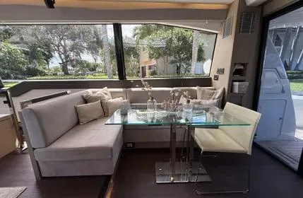  Yacht Photos Pics Luxurious interior of a 2018 Prestige 680 yacht with elegant seating and glass table.