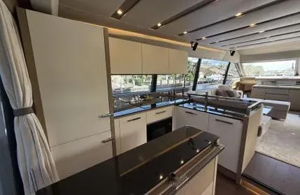  Yacht Photos Pics Luxurious interior of 2018 Prestige 680 yacht with modern kitchen and spacious seating area.
