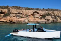 2021 Scorpion 40 boat in clear blue water near rocky coastline.