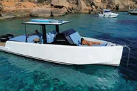 2021 Scorpion 40 boat in clear blue water near rocky shore.