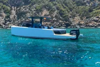 2021 Scorpion 40 boat on clear blue water near rocky coastline.