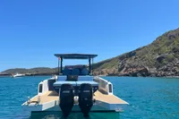 Scorpion 40 boat, 2021 model, anchored in clear blue water near rocky coastline.