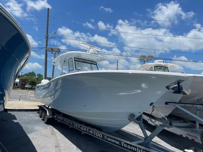 The Reel Commander Yacht Photos Pics 2026 Sea Fox 368 Commander boat on trailer under blue sky.