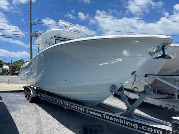 The Reel Commander Yacht Photos Pics 2026 Sea Fox 368 Commander boat on trailer under clear blue sky.
