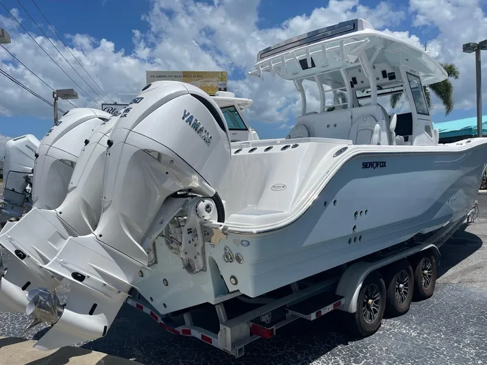 The Reel Commander Yacht Photos Pics 2026 Sea Fox 368 Commander boat with Yamaha engines, parked on a trailer under a blue sky.