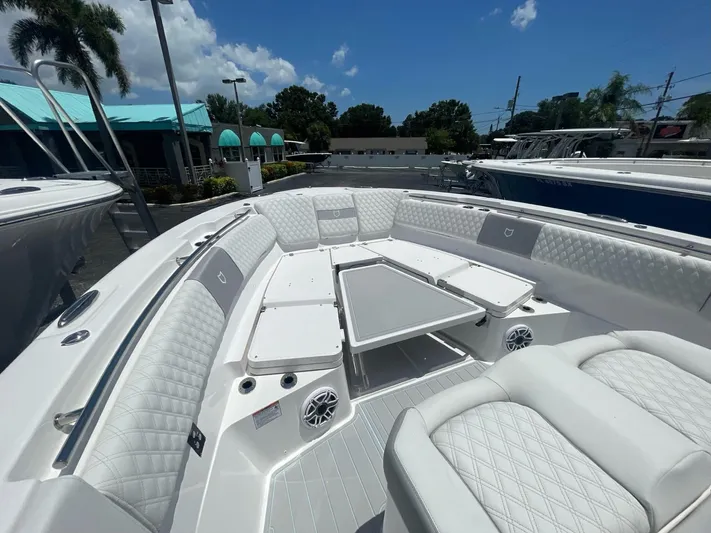 The Reel Commander Yacht Photos Pics 2026 Sea Fox 368 Commander boat interior with luxurious seating and table under a sunny sky.