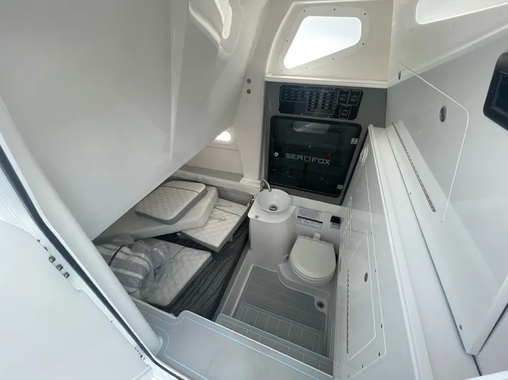 The Reel Commander Yacht Photos Pics 2026 Sea Fox 368 Commander cabin interior with compact bathroom and sleeping area.