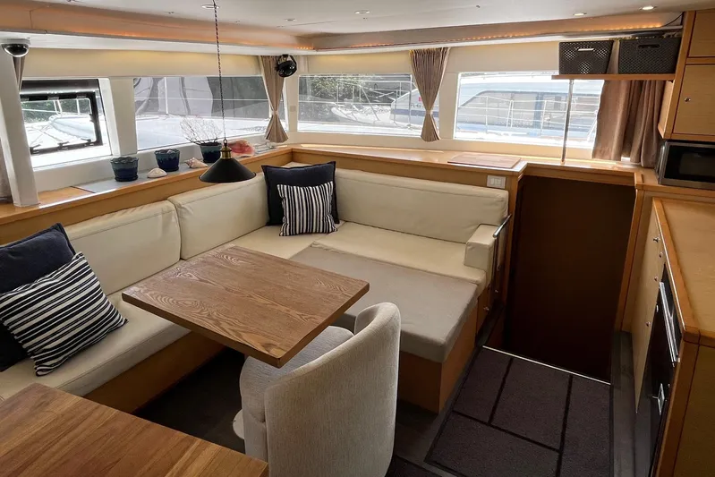  Yacht Photos Pics Interior of 2018 Lagoon 450 s yacht with cozy seating and wooden table.