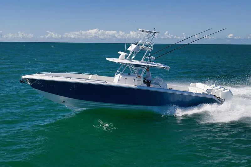  Yacht Photos Pics 2021 Bahama 41 boat cruising on open ocean with fishing rods.