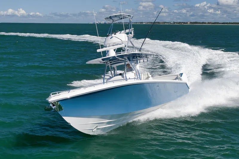  Yacht Photos Pics 2021 Bahama 41 boat cruising on open water, creating a dynamic wake.