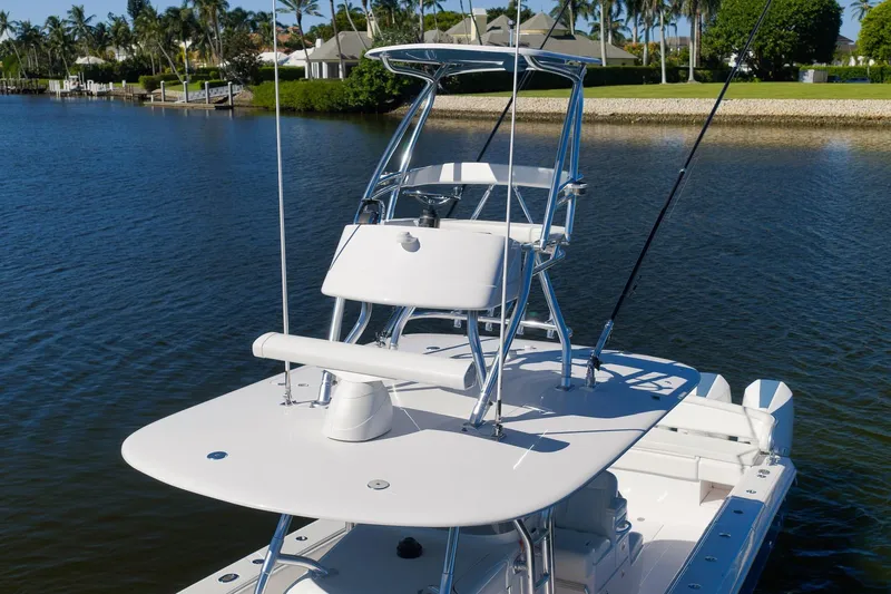  Yacht Photos Pics 2021 Bahama 41 boat with elevated helm, docked on a serene waterway.
