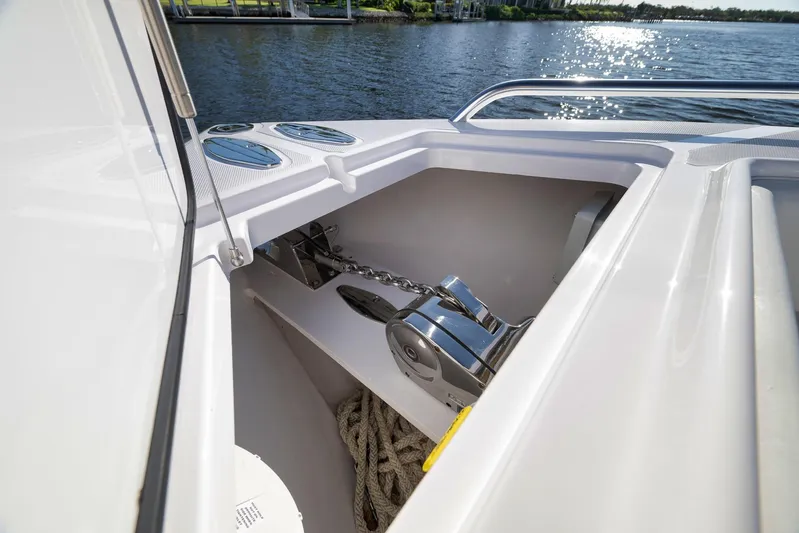  Yacht Photos Pics Anchor compartment of 2021 Bahama 41 boat with chain and rope, near water.