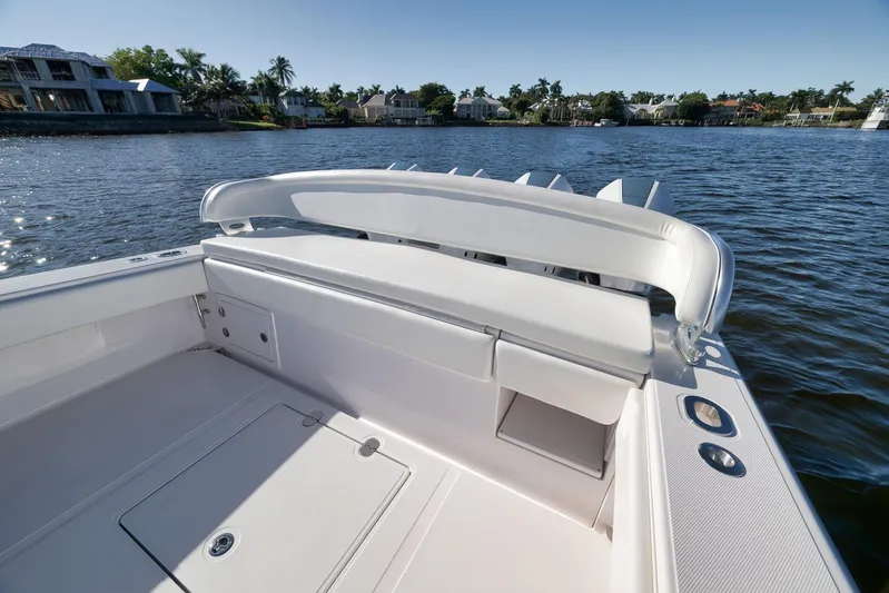  Yacht Photos Pics 2021 Bahama 41 boat with sleek white seating, docked by waterfront homes.
