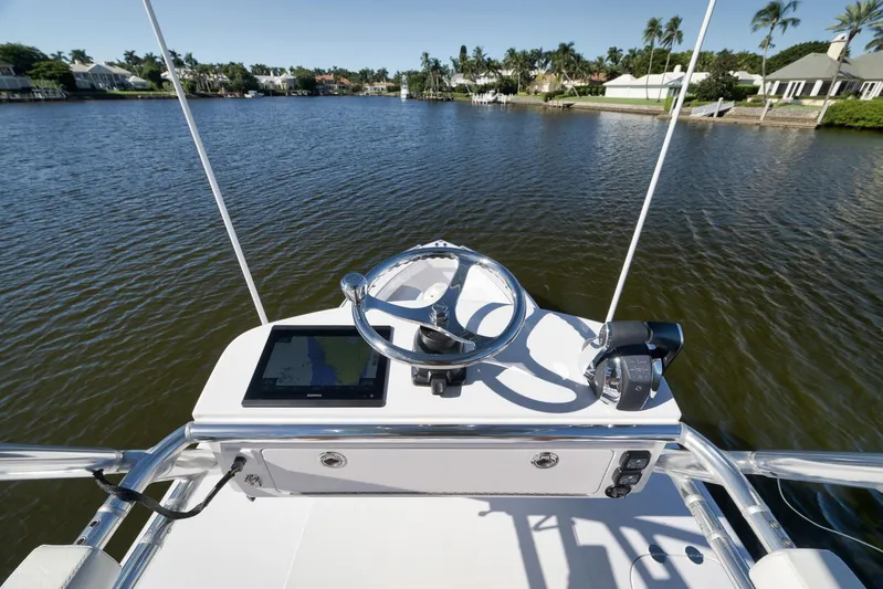  Yacht Photos Pics Cockpit view of 2021 Bahama 41 boat with steering wheel and navigation system.