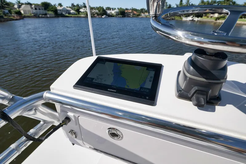  Yacht Photos Pics Navigation system on 2021 Bahama 41 boat, featuring Garmin display, near waterfront homes.