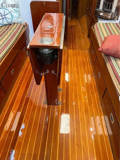 Perelandra Yacht Photos Pics Interior of 1968 Hinckley Bermuda 40 with polished wooden flooring and cozy seating.