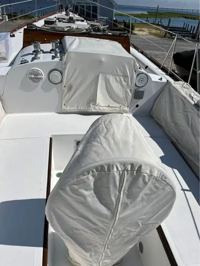 Perelandra Yacht Photos Pics 1968 Hinckley Bermuda 40 sailboat deck with covered equipment and scenic waterfront view.