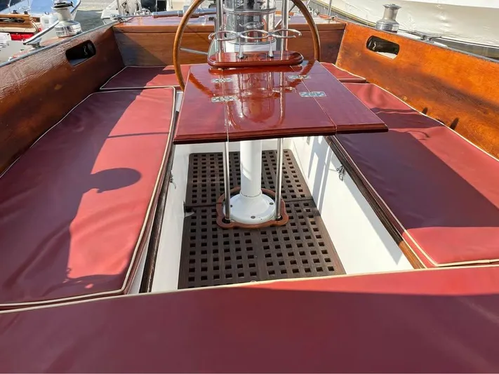 Perelandra Yacht Photos Pics 1968 Hinckley Bermuda 40 sailboat cockpit with red cushions and wooden accents.