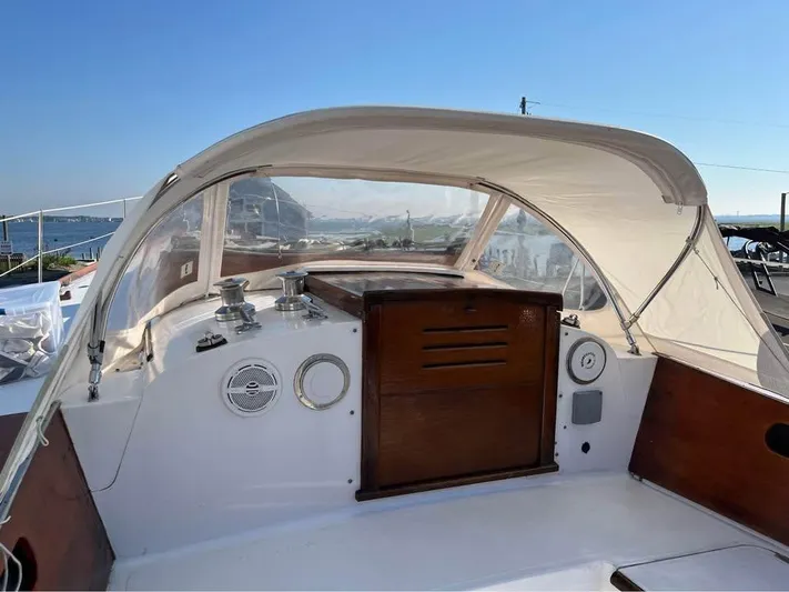 Perelandra Yacht Photos Pics 1968 Hinckley Bermuda 40 sailboat cockpit with canopy, featuring wooden accents and ocean view.