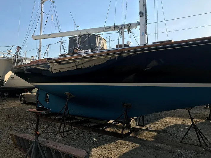 Perelandra Yacht Photos Pics 1968 Hinckley Bermuda 40 sailboat on stands, blue hull, in a boatyard.