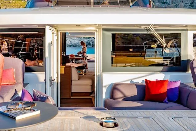  Yacht Photos Pics Luxurious Lagoon SIXTY 7 yacht interior, 2026 model, featuring plush seating and scenic ocean view.