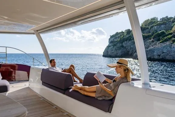  Yacht Photos Pics Couple relaxing on Lagoon SIXTY 7 yacht, 2026 model, with scenic ocean view.