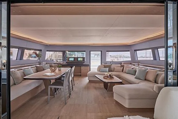  Yacht Photos Pics Luxurious interior of 2026 Lagoon SIXTY 7 yacht with elegant seating and dining area.