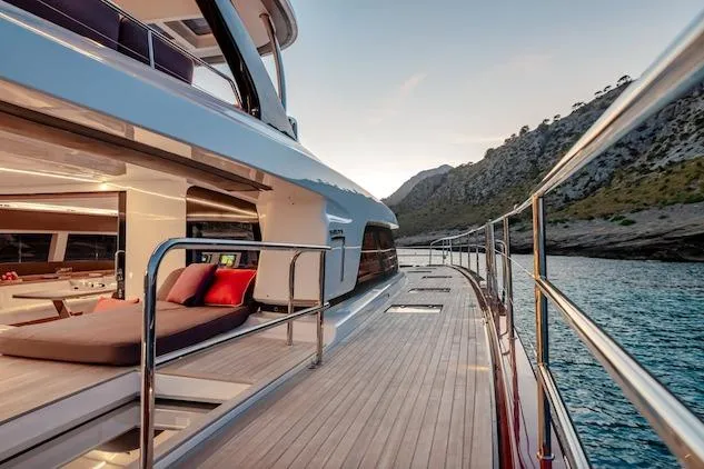  Yacht Photos Pics Luxurious 2026 Lagoon SIXTY 7 yacht with elegant deck, scenic coastal view.